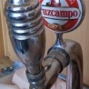 Columna Cervecera. Bronce blanco. Marca Cruzcampo.