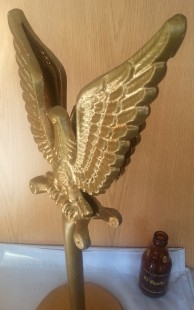 Águila grande en hierro. Dorada. Sobre pedestal artesanal.