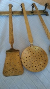 Utensilios de cocina en bronce. Conjunto de accesorios fuertes y pesados.